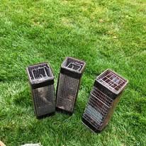 Three rectangular wire traps on green grass