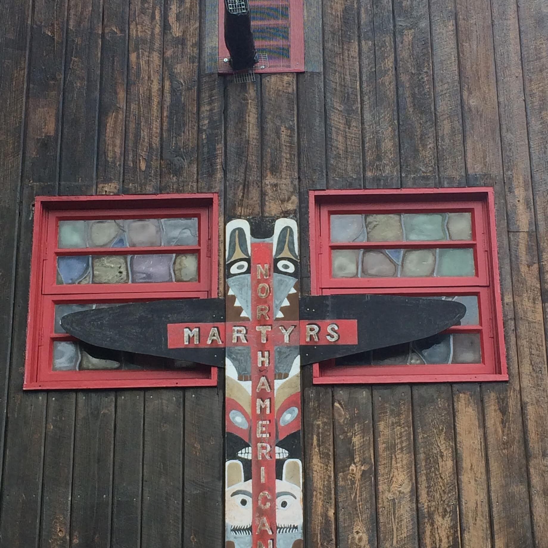 Wooden totem with red windows